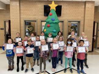 Picture of November students of the month holding their certificates.