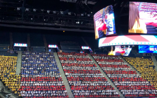 Students sitting by shirt color to replicate a large US flag.