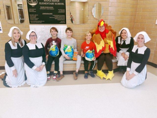 Office staff dressed as pilgrims and a turkey with the Gobble Off winners.
