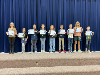 Upper grade Reflections winners with their certificates and ribbons.