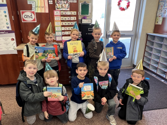 First graders holding Mercy Watkins books.