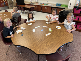 Students eating pie together.