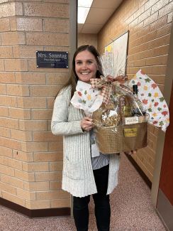 Mrs. Sonntag holding a gift basket.