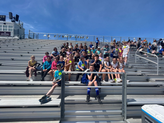 Students on the bleachers during the track meet.